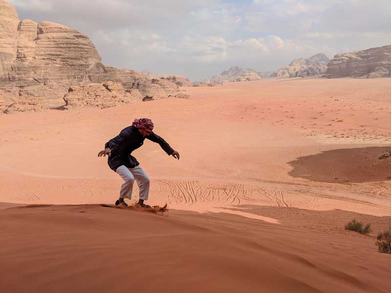 sandboarding Bedouin guide