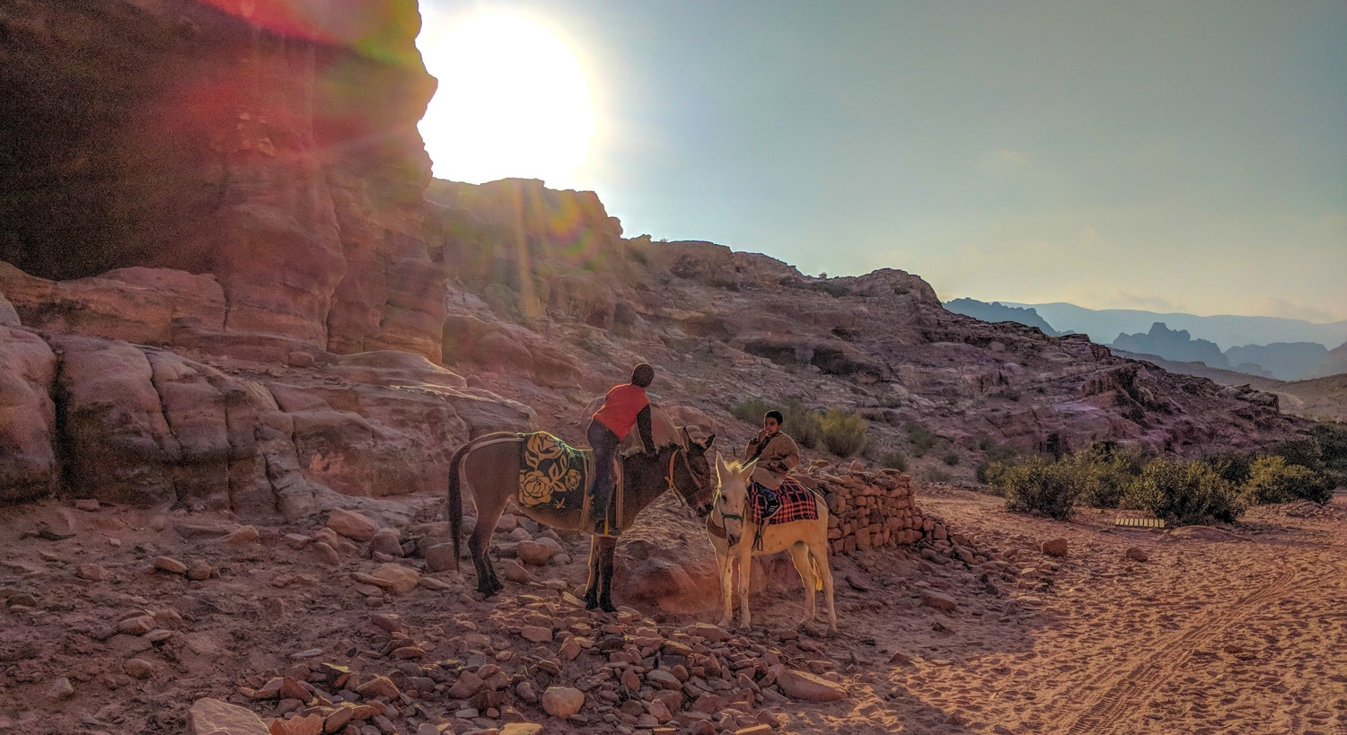 Local kids on horseback near the climb to the cathedral of petra