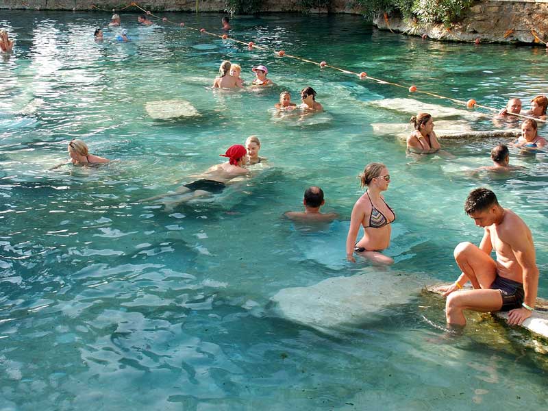 Bathers in the warm wateres of the Sacred Thermal Pool