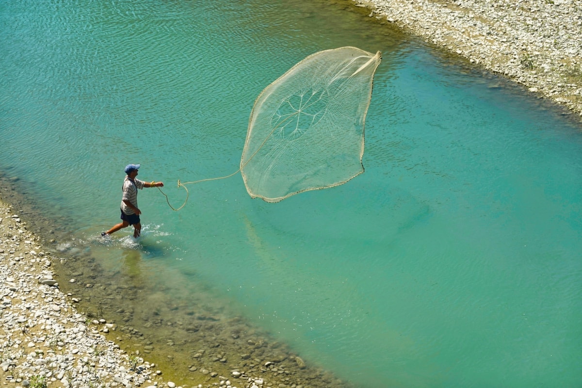 man fishing in berat river